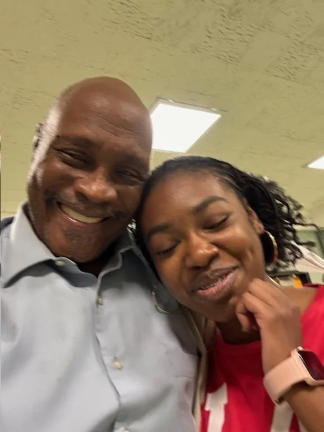 Smiling older man and younger woman.