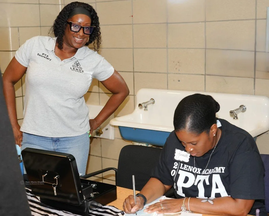 Two women at a table in a tiled room