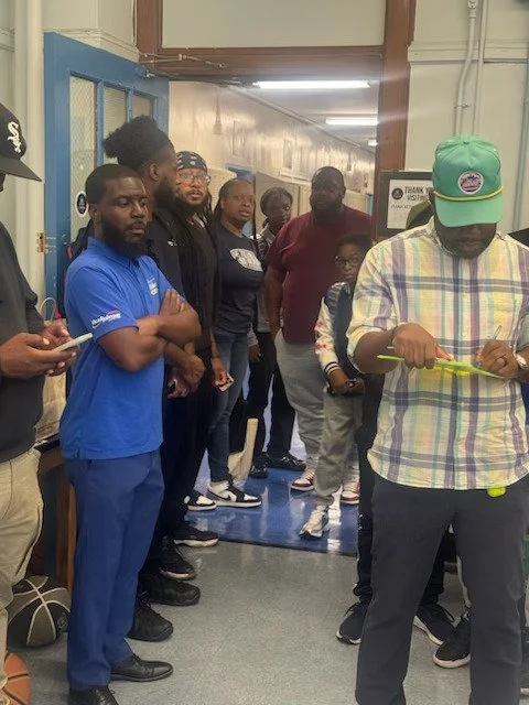 A group of diverse adults and a child standing in a hallway