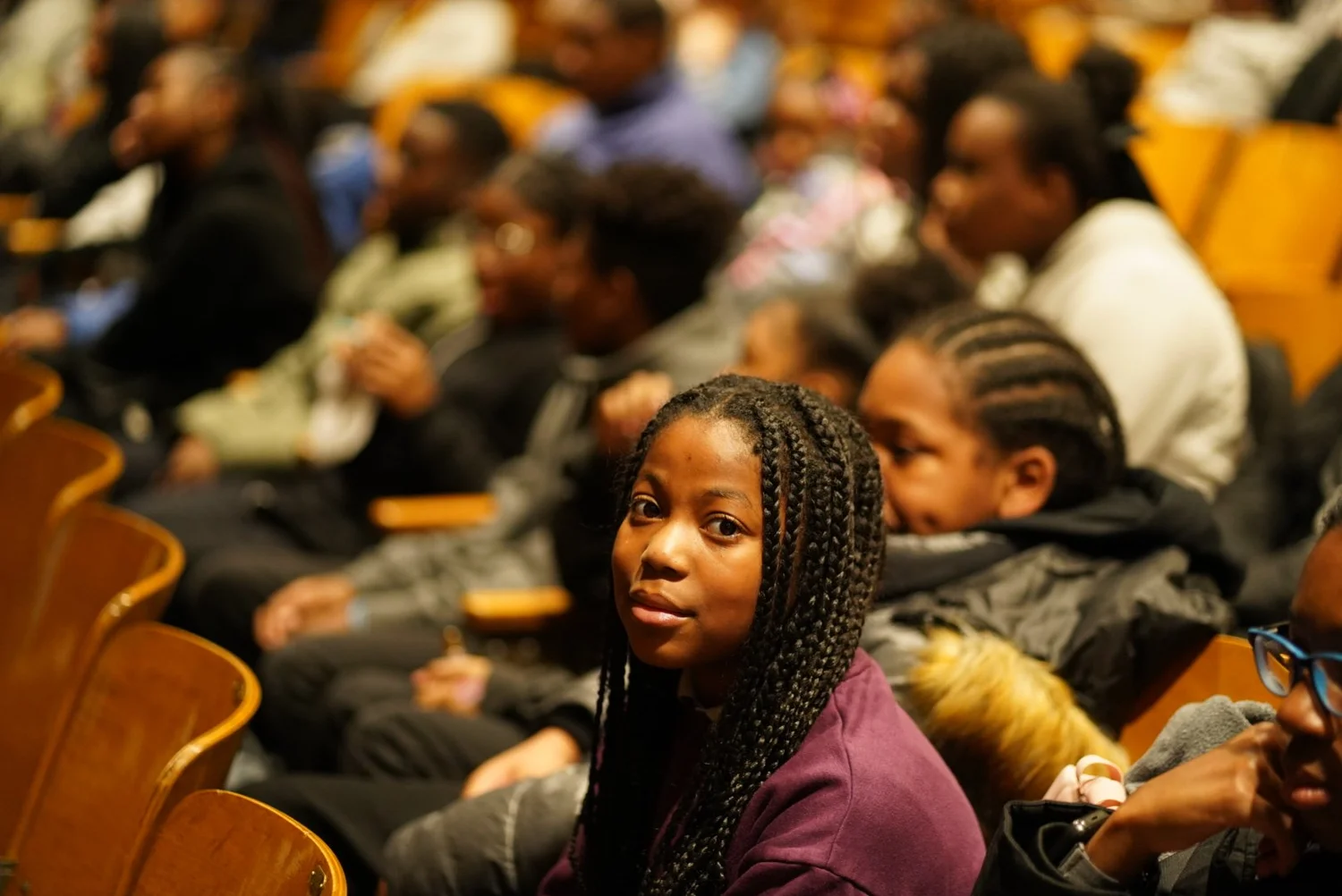Young people with braided hairstyles seated
