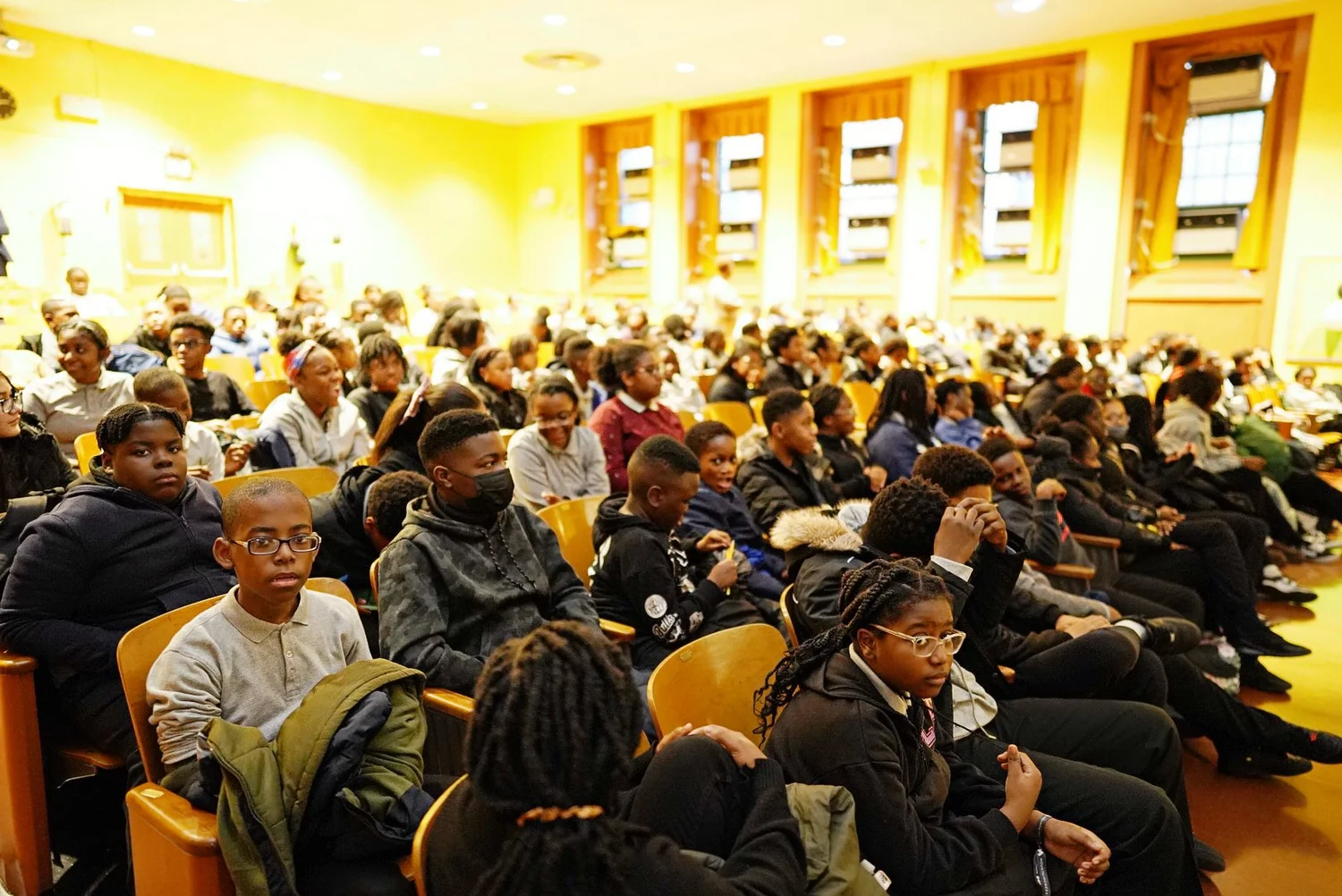 Large group of students seated in a school auditorium