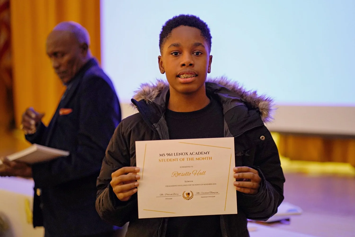 Young student holding a certificate 