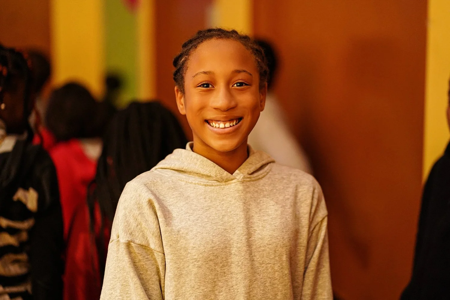 Smiling young person with braided hair