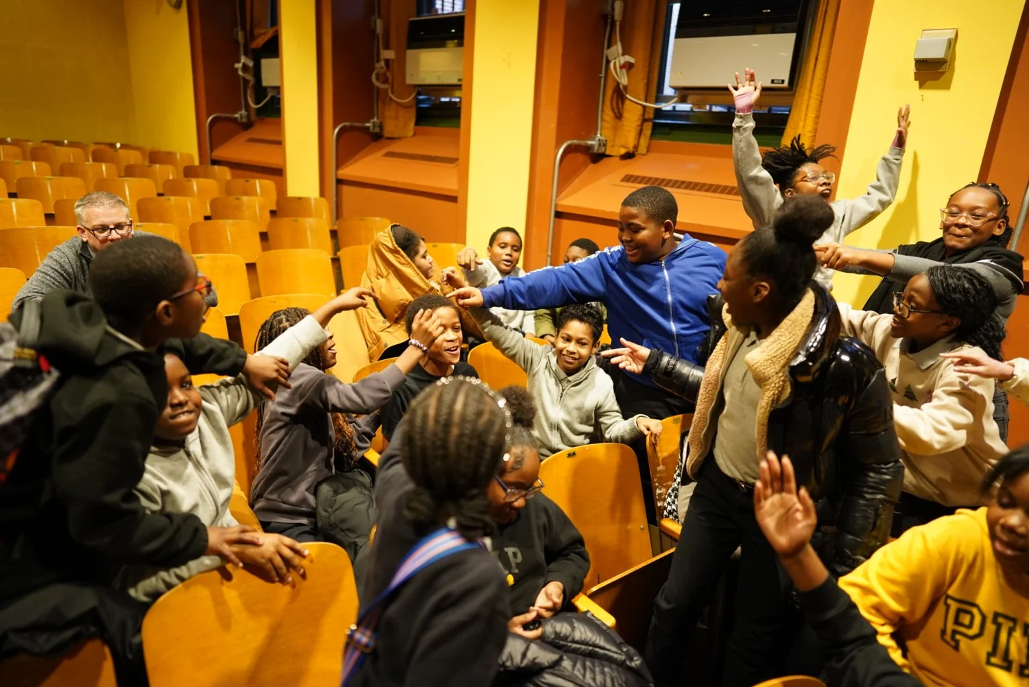 Group of diverse children enthusiastically interacting and reaching out 