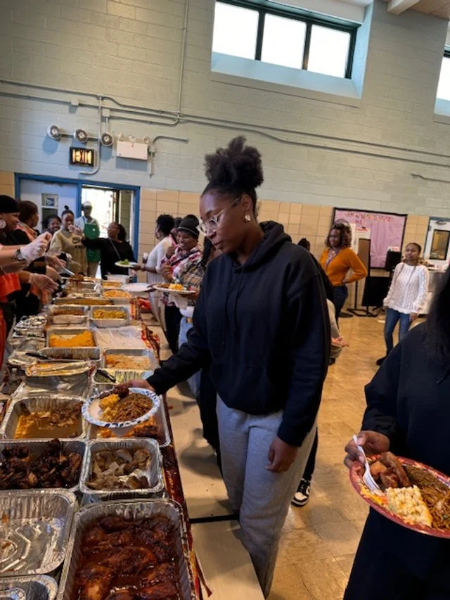 People serving themselves various dishes