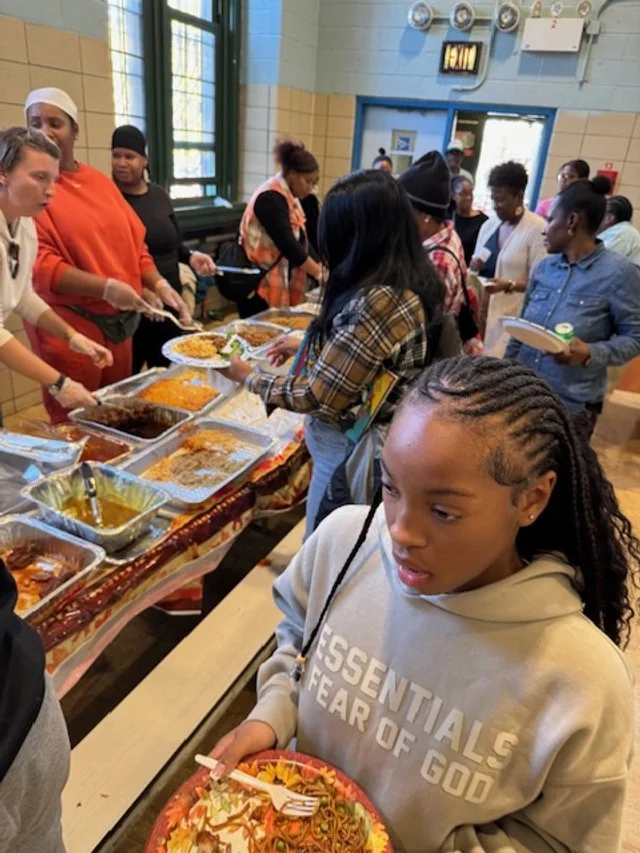 Young woman with braided hair holding a plate of food