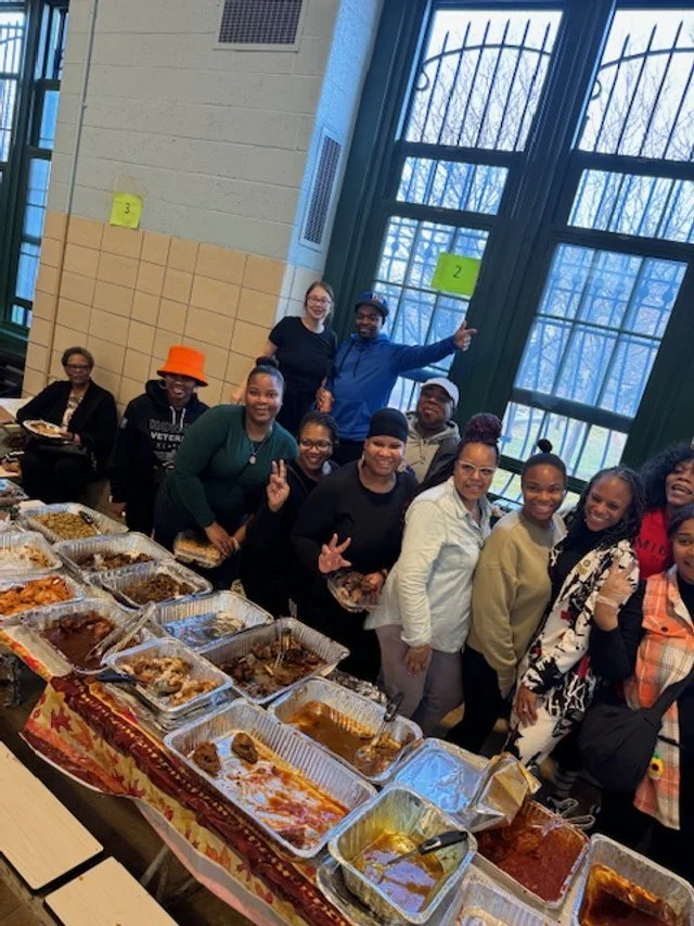 Woman in black dress speaking into a microphone 