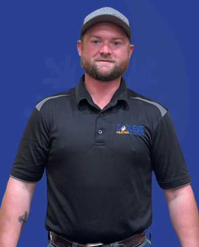 Man wearing a black polo shirt with Cool Fix Heating & Cooling logo and a gray cap, standing against a blue background with subtle snowflake design.