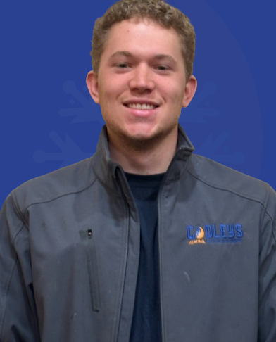 Young man with curly hair smiling and wearing a gray jacket with a Coodley's Heating logo.