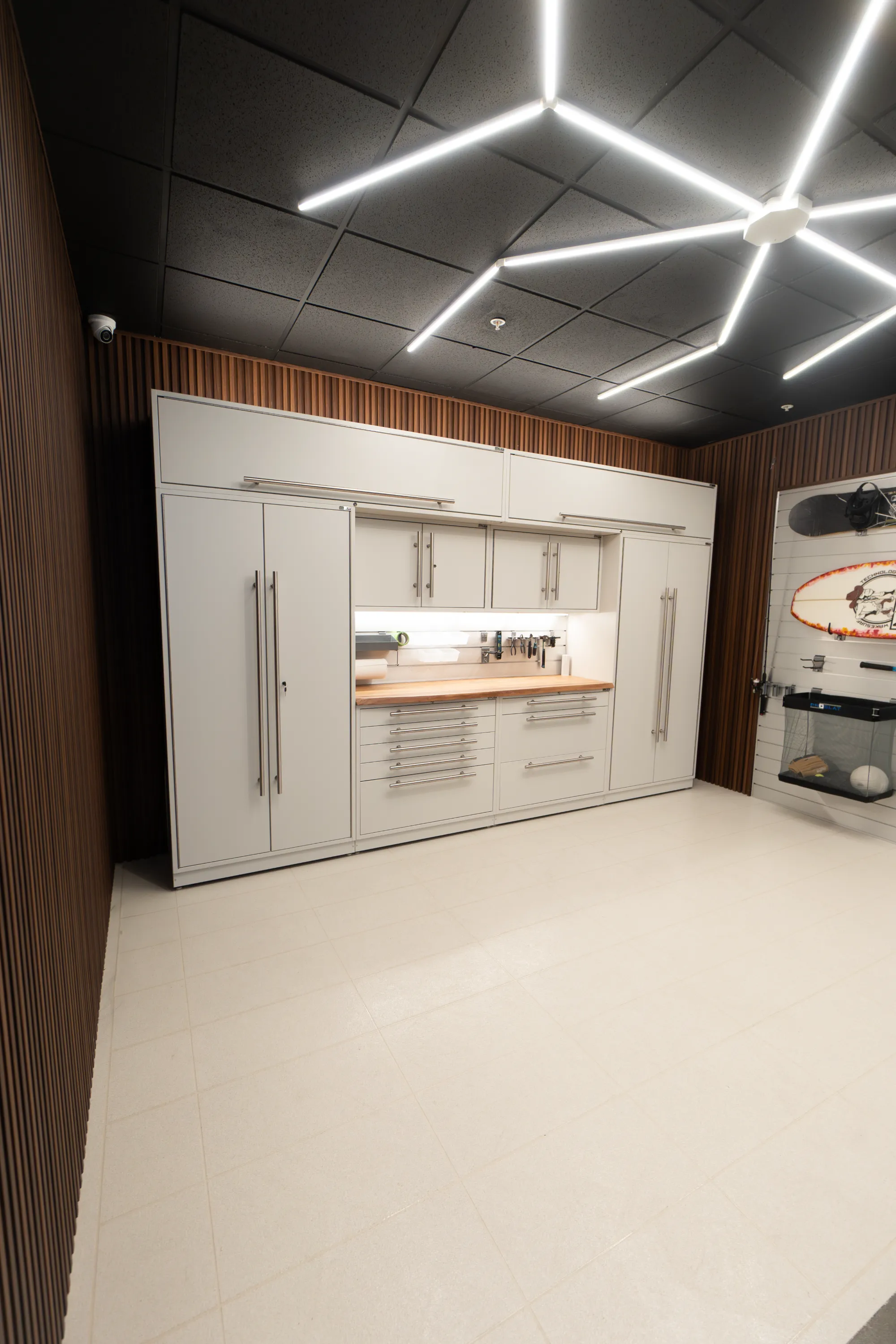 A room with a surfboard on the wall.