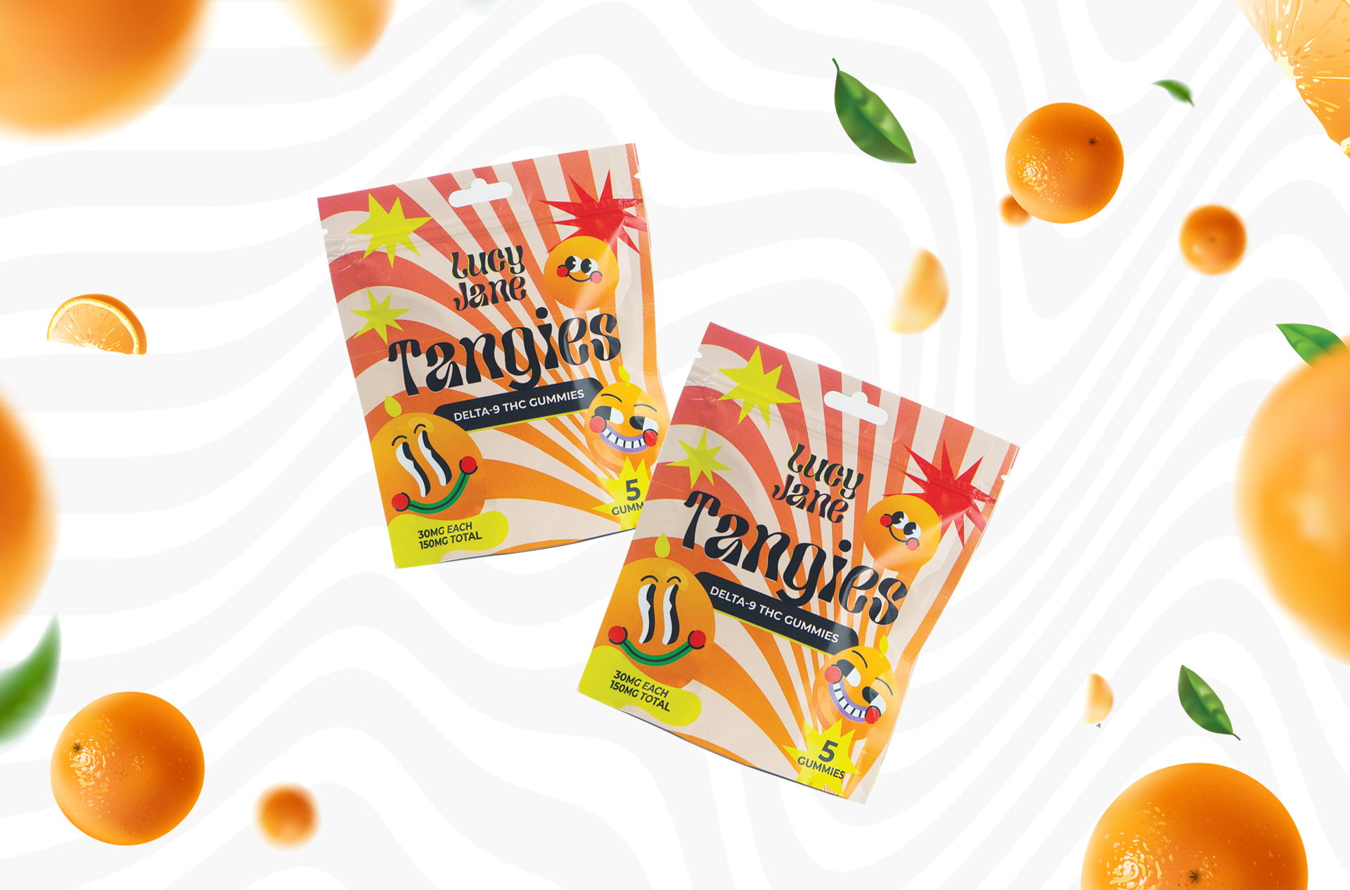 Two packages of Lucy Jane Tangies Delta-9 THC Gummies surrounded by floating whole and sliced oranges and green leaves.