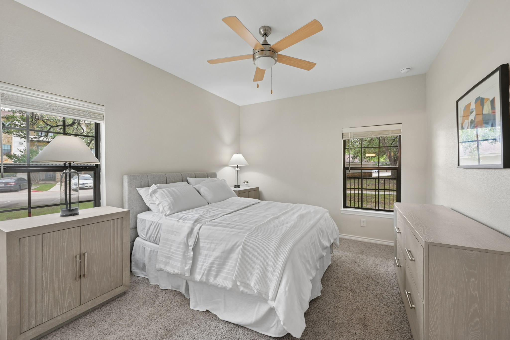 Staged living room with furniture and two windows