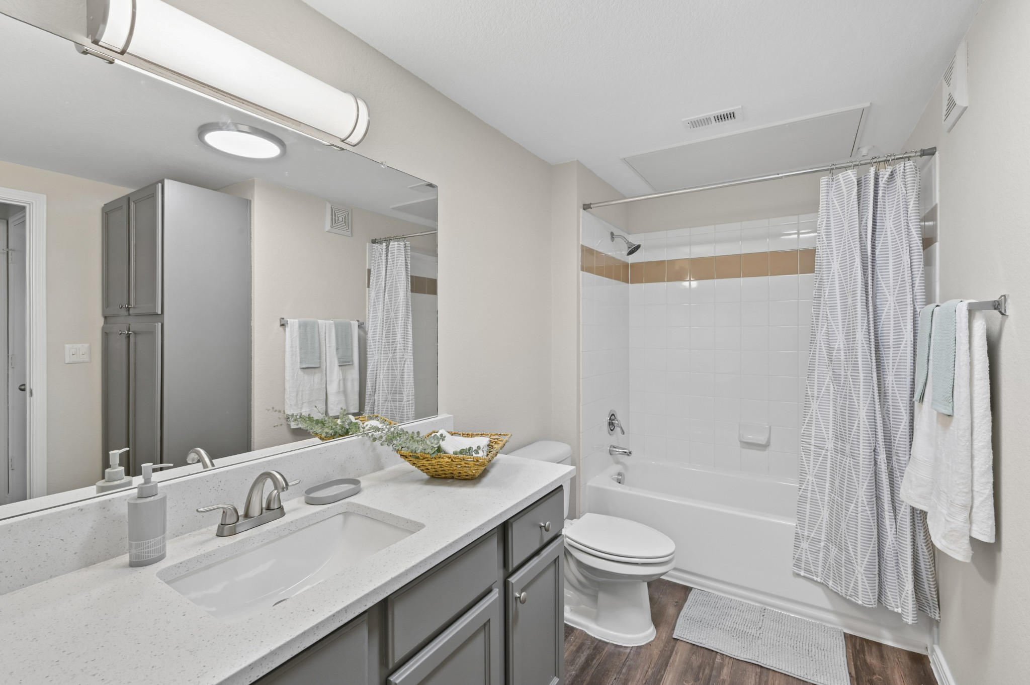 Bathroom with vanity and entrance to closet