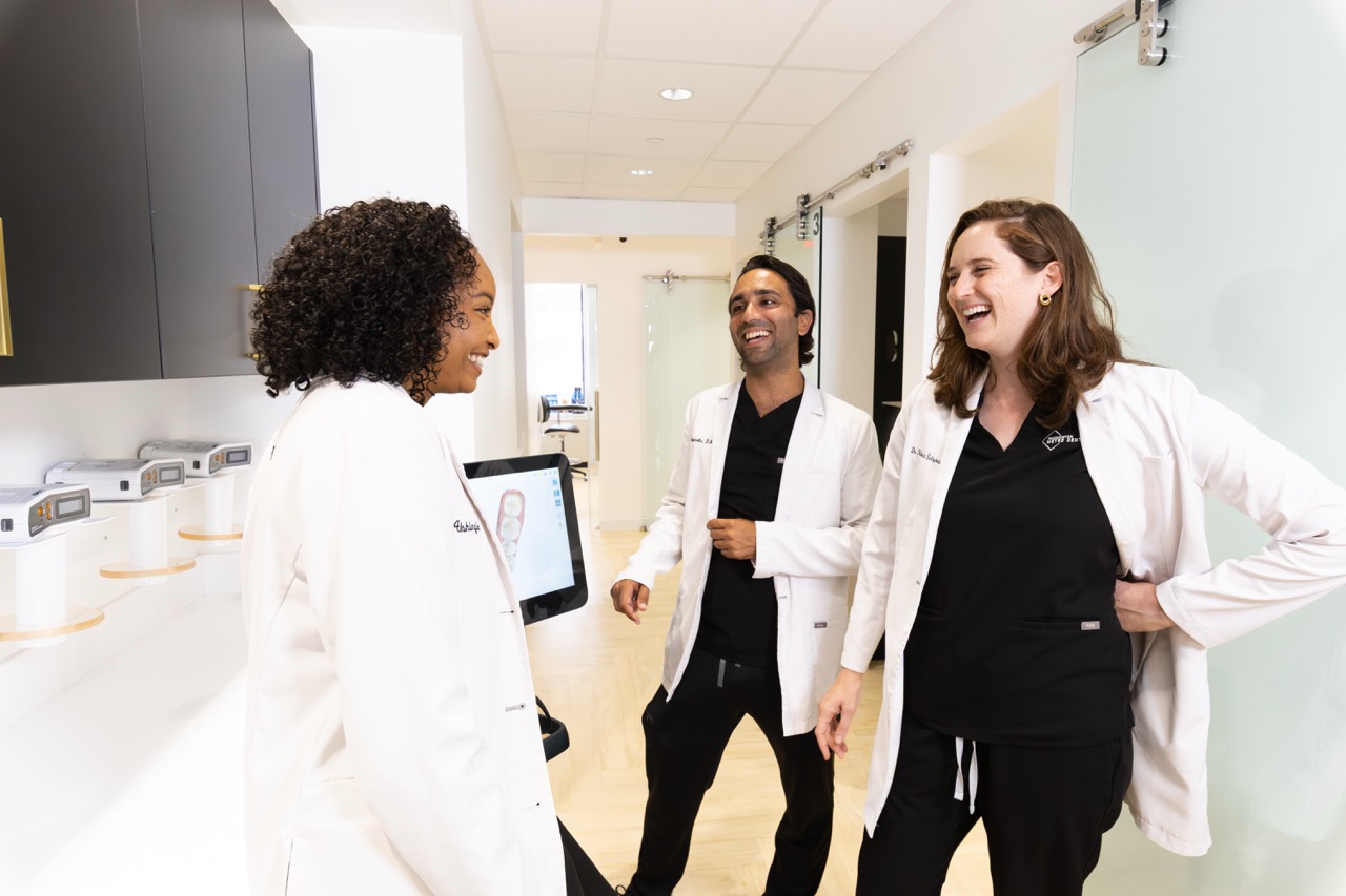 Professional dentist laughing while collaborating