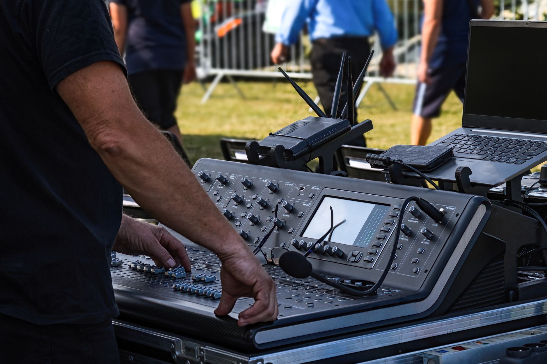 Tontechniker bedient ein Mischpult bei einem Open-Air-Konzert