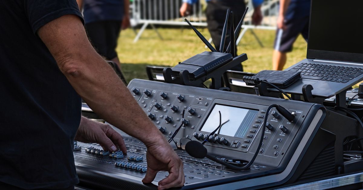 Tontechniker bedient ein Mischpult bei einem Open-Air-Konzert