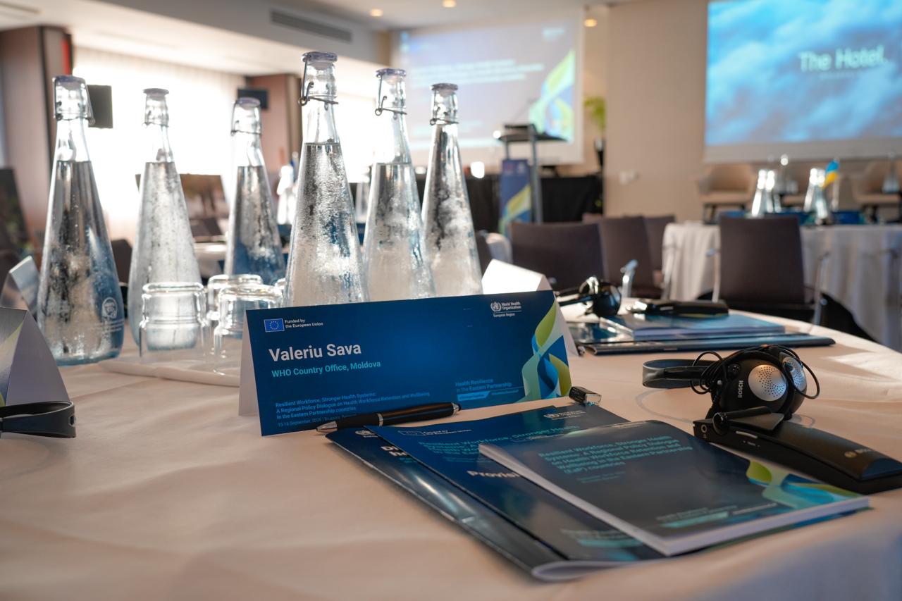Conference table prepared with interpretation headsets and event materials