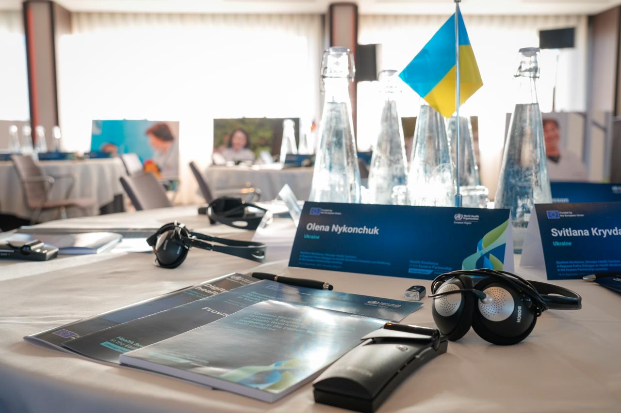 Delegate place setting with Ukrainian flag and interpretation headset