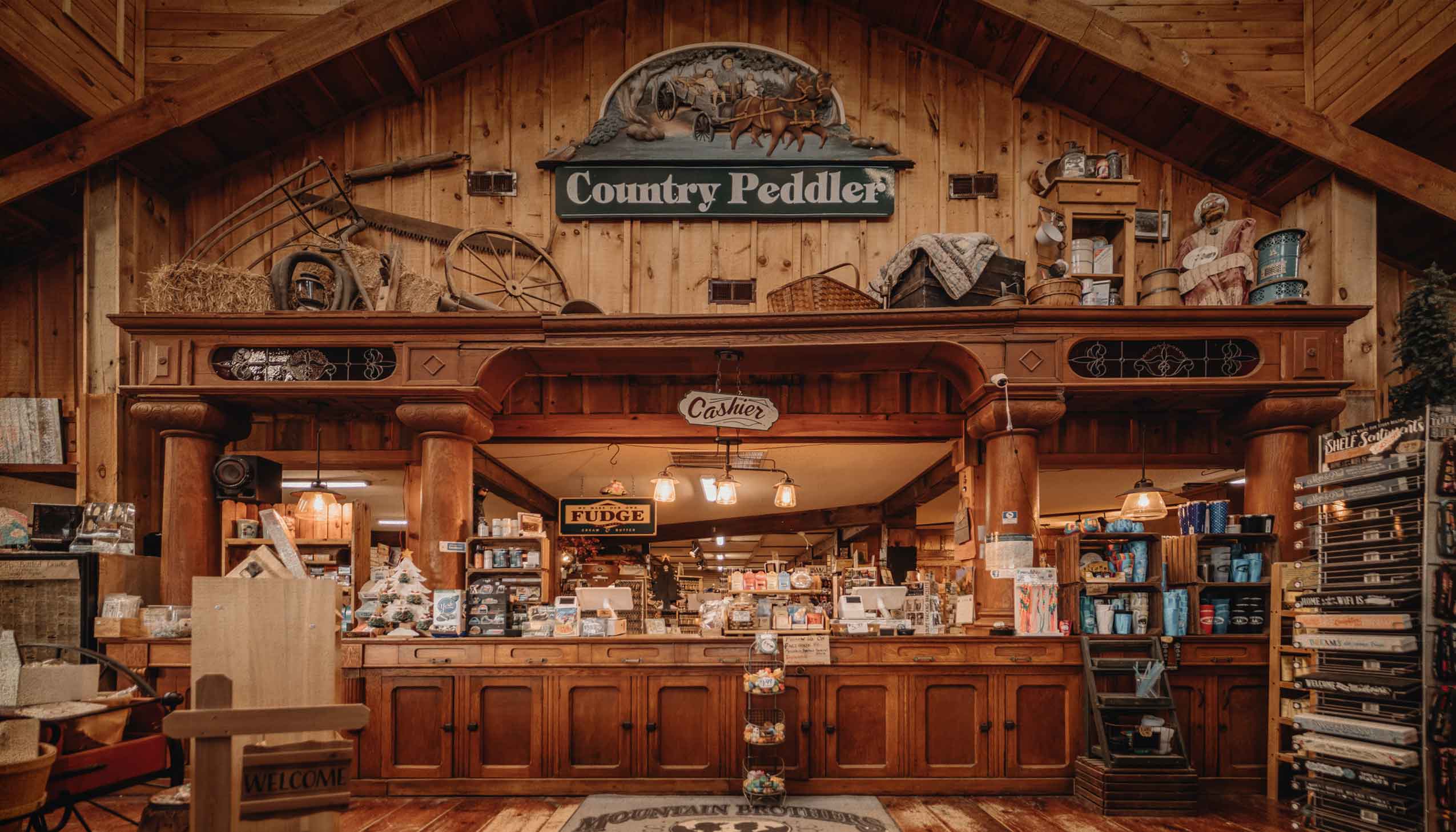 A bag of Mountain Brothers General Store coffee and cup sitting on a picnic table with the Smoky Mountains in the background.