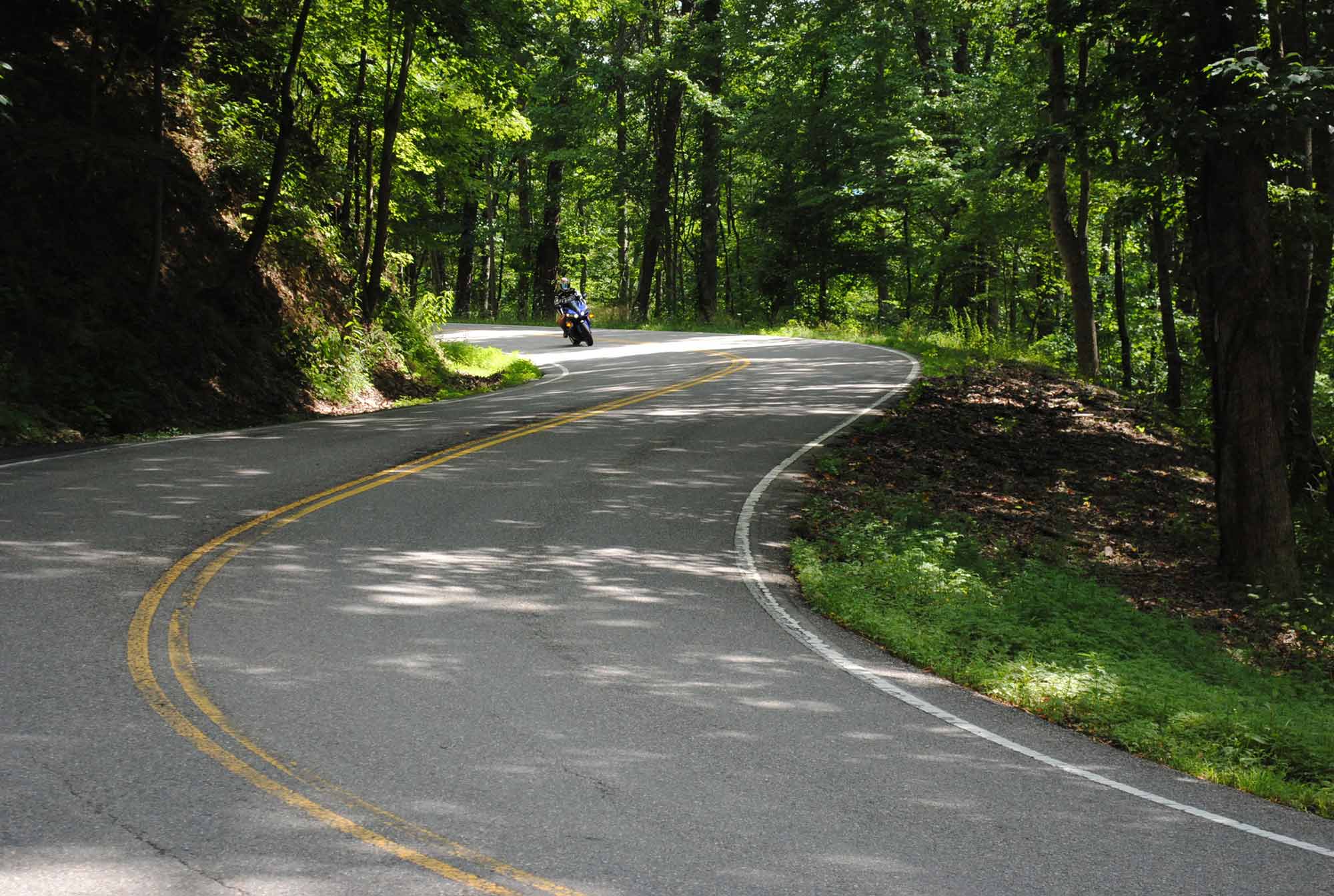 Image of a motorcycle cruising through the curves in The Dragon.
