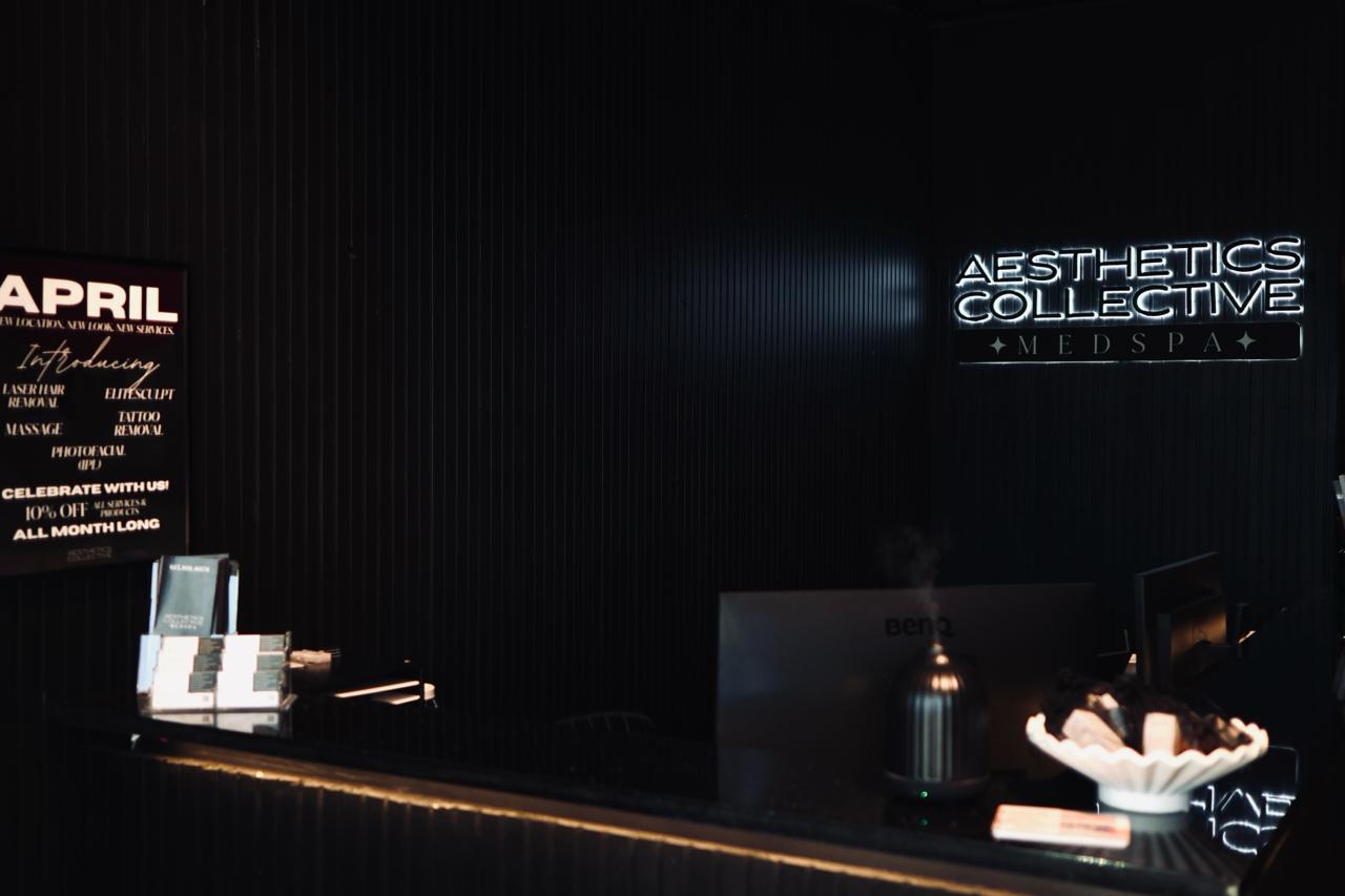 Display rack with various styles of earrings including gold stars, hoop earrings, and cream and brown resin hoops on black cards.