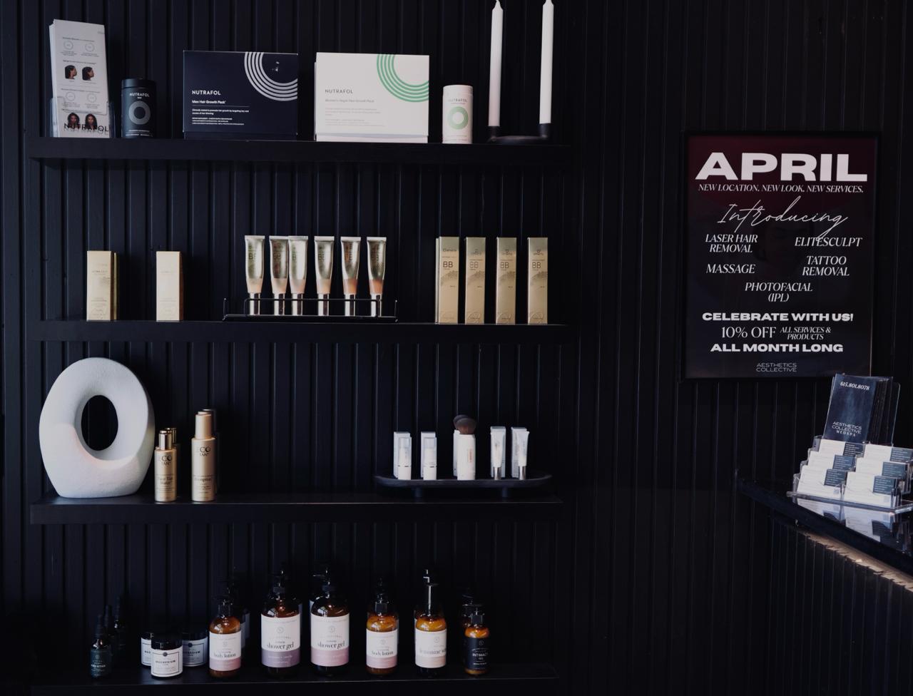 Clinical room with a black chair, white door marked number 3 open, white storage cabinet, and shelves with skincare products and Botox promotional materials.