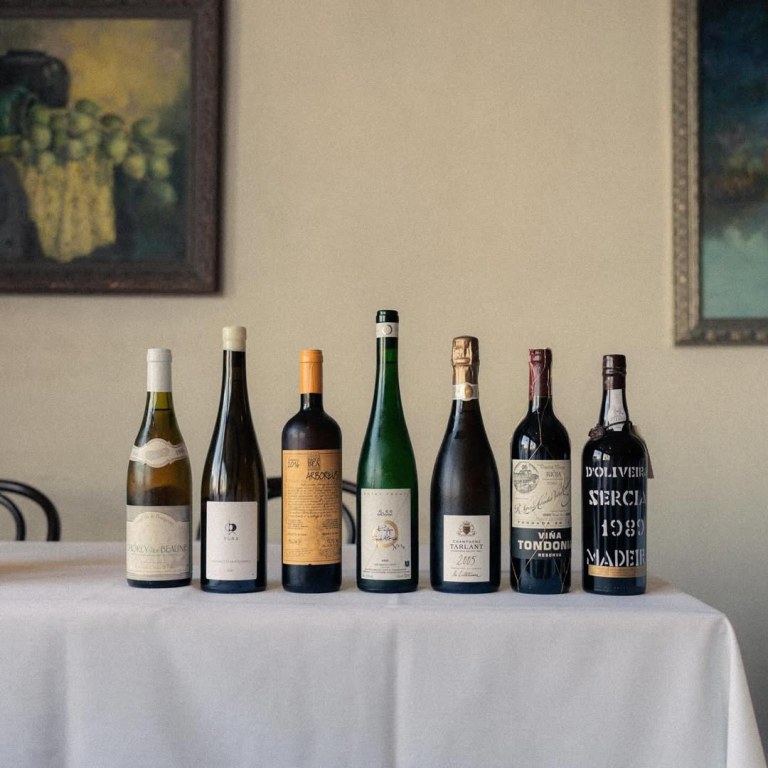 A curated lineup of bottles from Anajak Thai's wine program, including Tarlant Champagne, Viña Tondonia, and a 1989 D'Oliveira Sercial Madeira