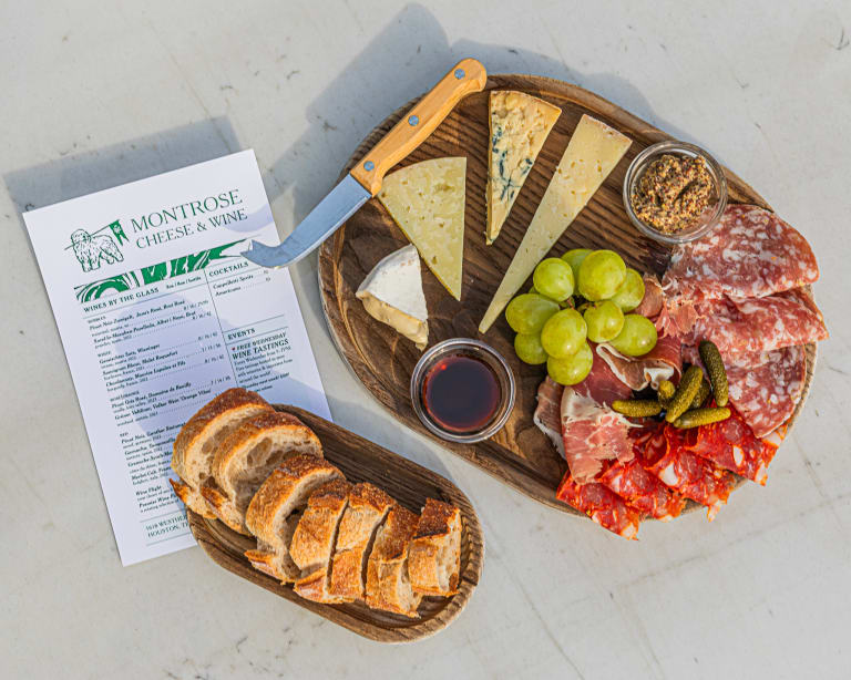 A cheese and charcuterie board with the Montrose Cheese & Wine menu