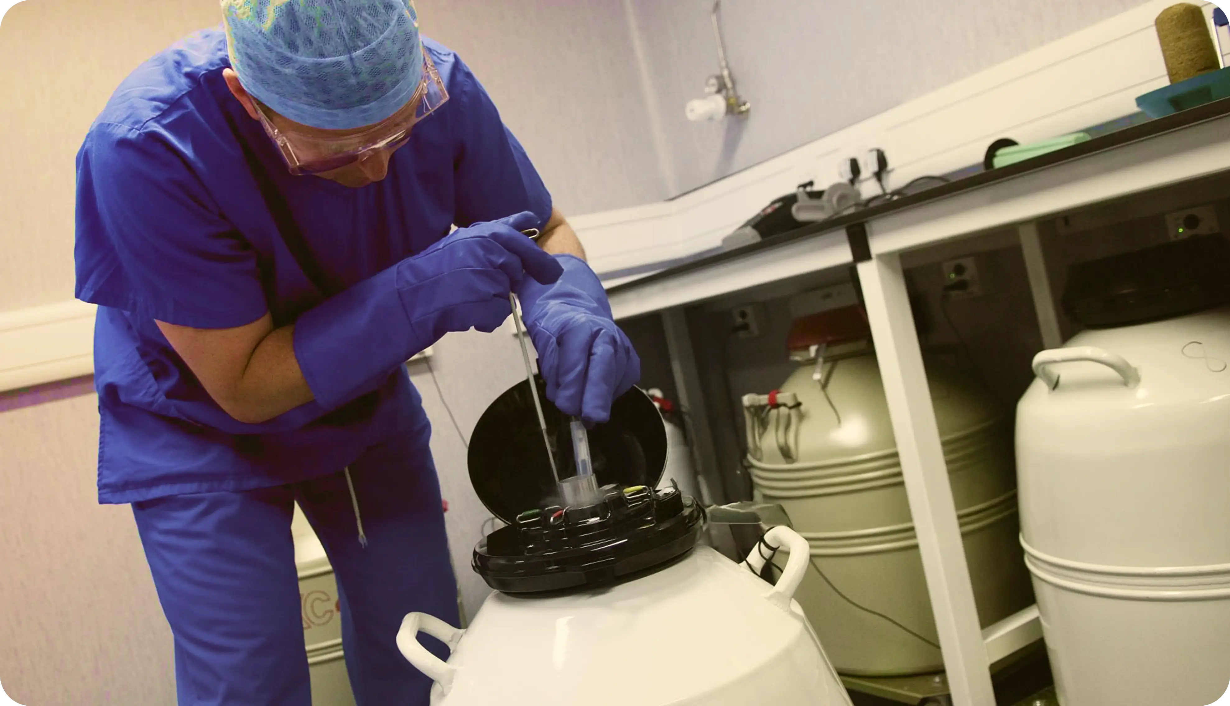 Man measuring the liquid nitrogen level of a cryogenic tank