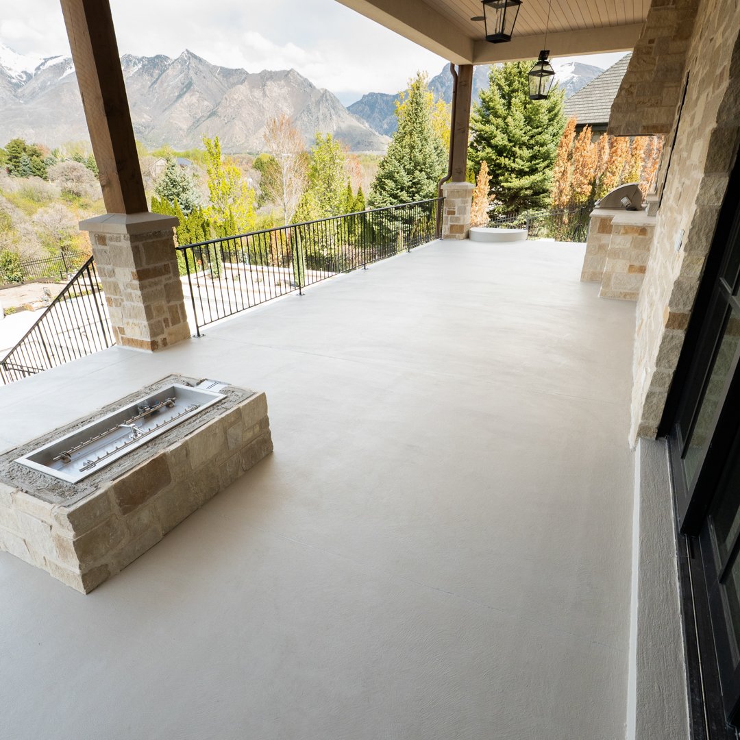 Residential waterproof deck with firepit and mountain view by Lifetime Coatings in Utah