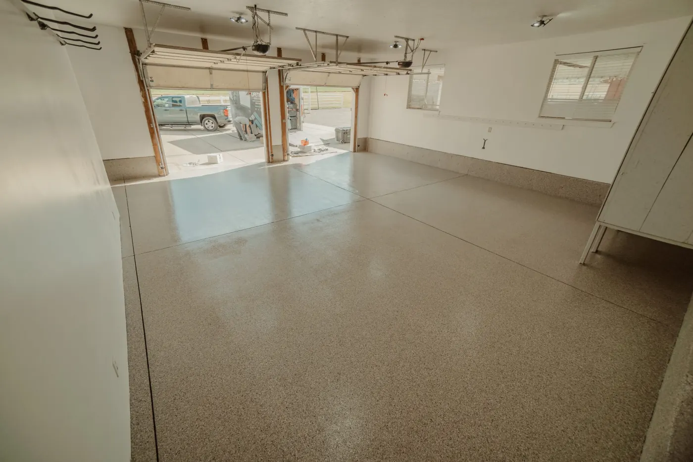 Riverbed flake epoxy garage floor by Lifetime Coatings