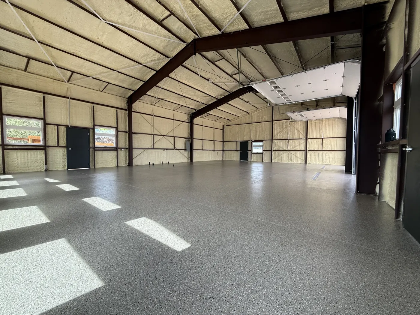Riverbed flake epoxy garage floor by Lifetime Coatings