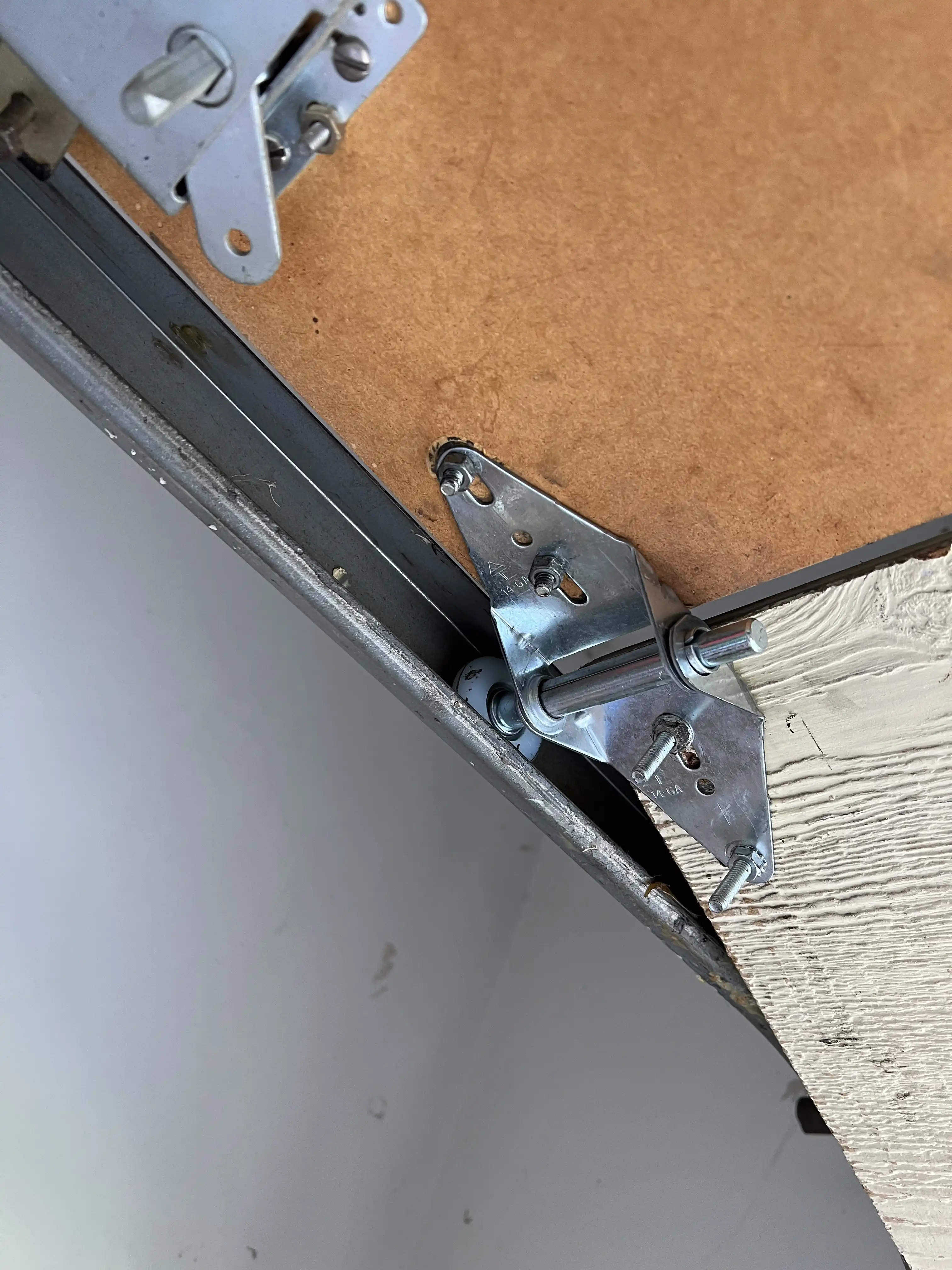 New garage door hinge installed during a repair in Overland Park, KS