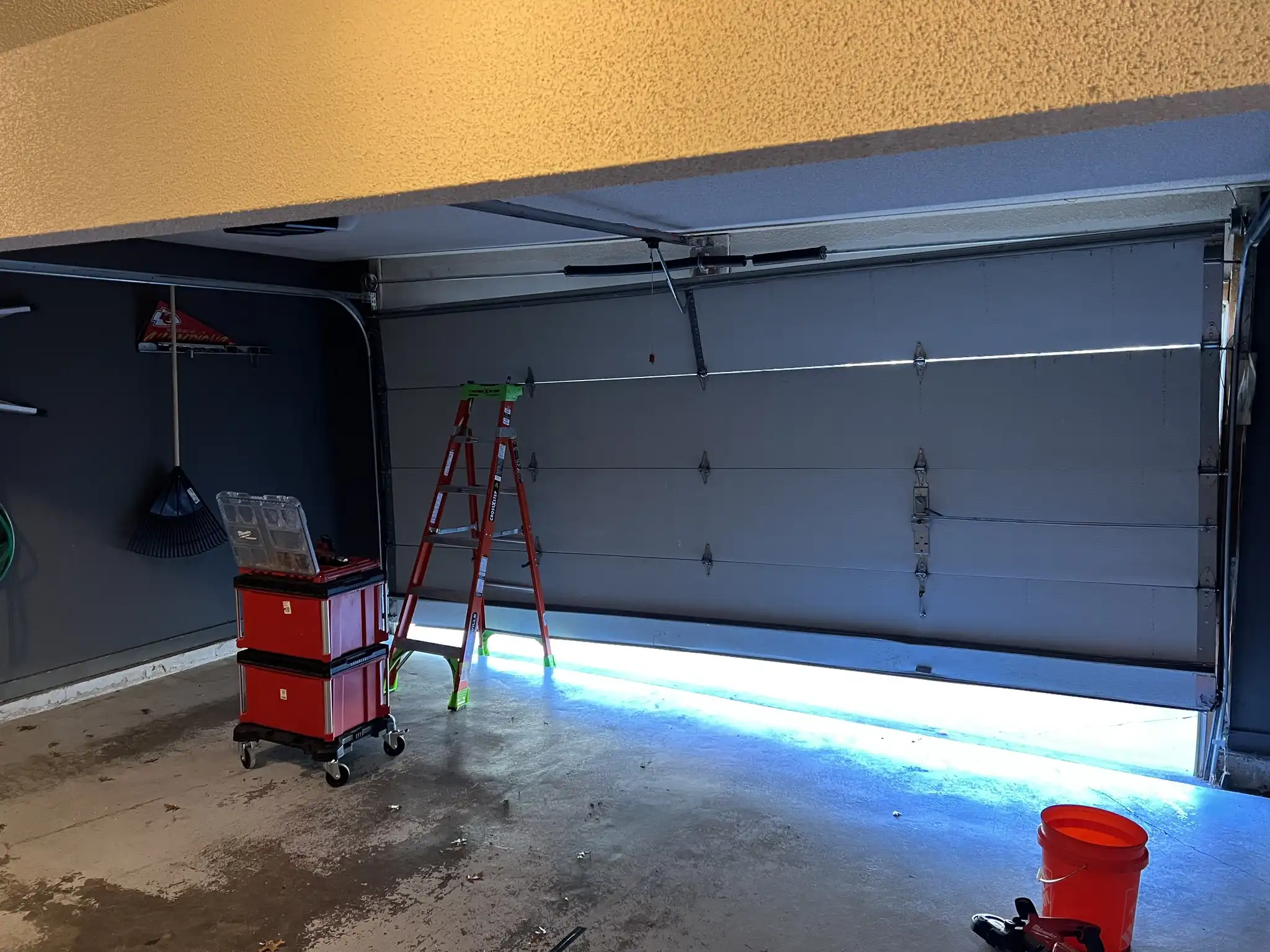 Damaged garage door in Olathe, KS before off-track service