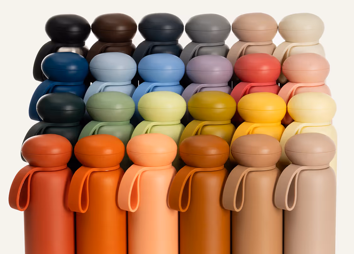 Rows of colorful matte-finish water bottles with rounded caps and loop handles in various shades of black, brown, blue, green, yellow, red, orange, and beige.