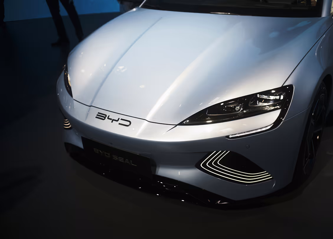 Front view of a silver BYD Seal electric car showing the headlights, BYD logo, and LED daytime running lights.