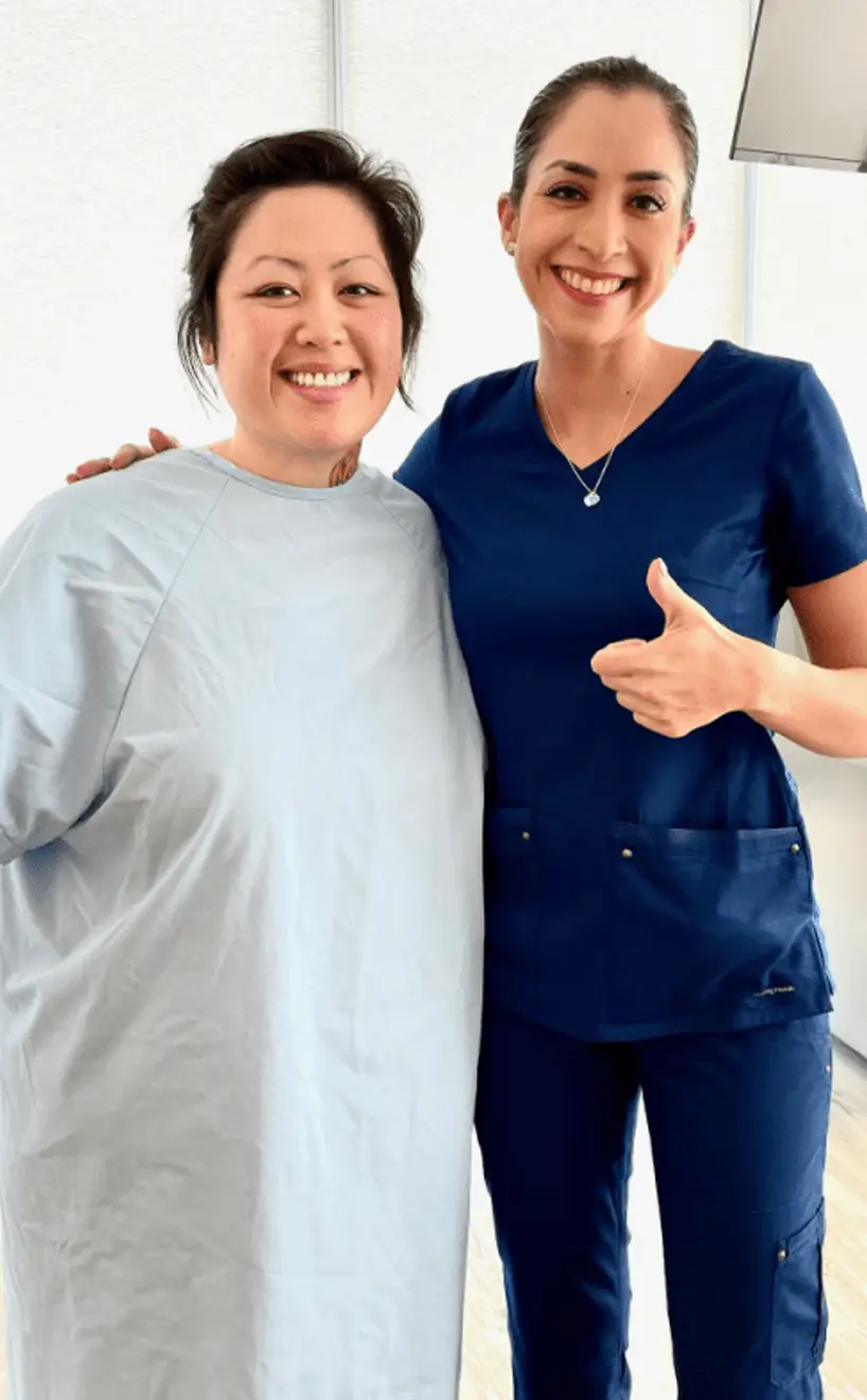 Happy bariatric patient giving a thumbs-up alongside a caring nurse after a successful weight loss procedure, showcasing the personalized recovery care at Dr. Sandy Bariatrics.