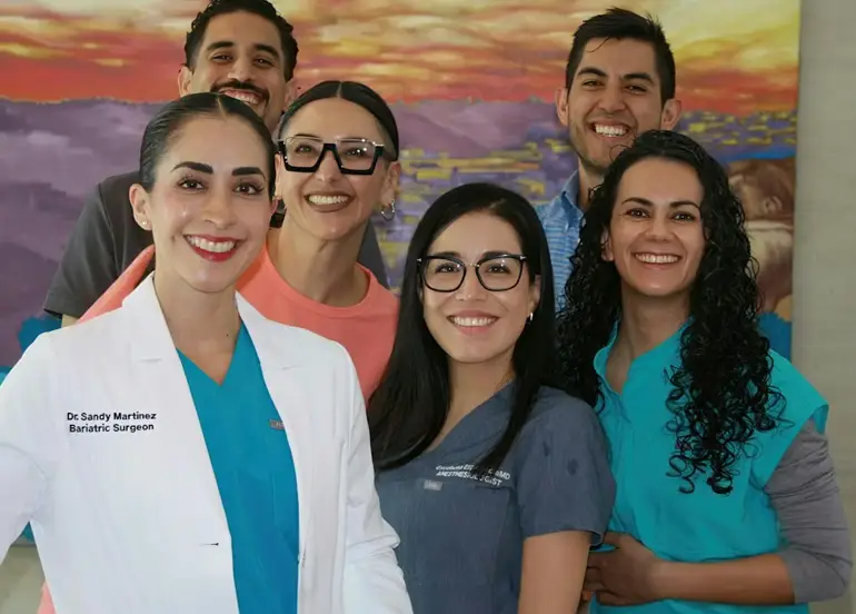 A diverse team of six smiling healthcare professionals at Dr. Sandy Bariatrics, providing a multidisciplinary approach to safer and personalized weight loss surgery in Tijuana.