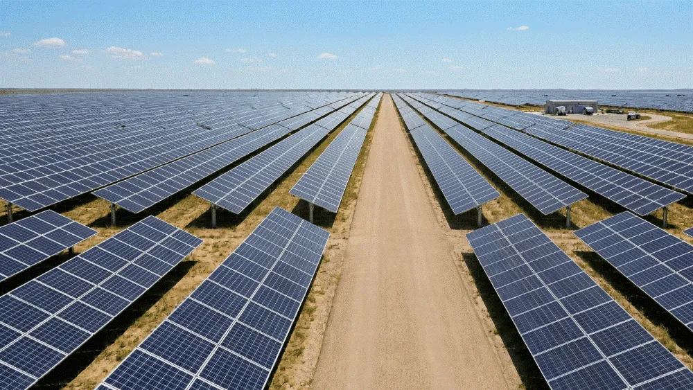 A large field of solar panels in the middle of nowhere.