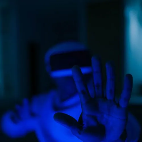 A person's hand in blue light
