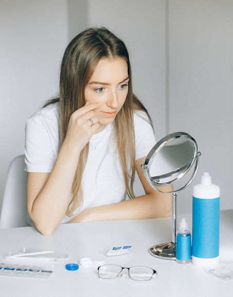 Woman putting on contact lenses