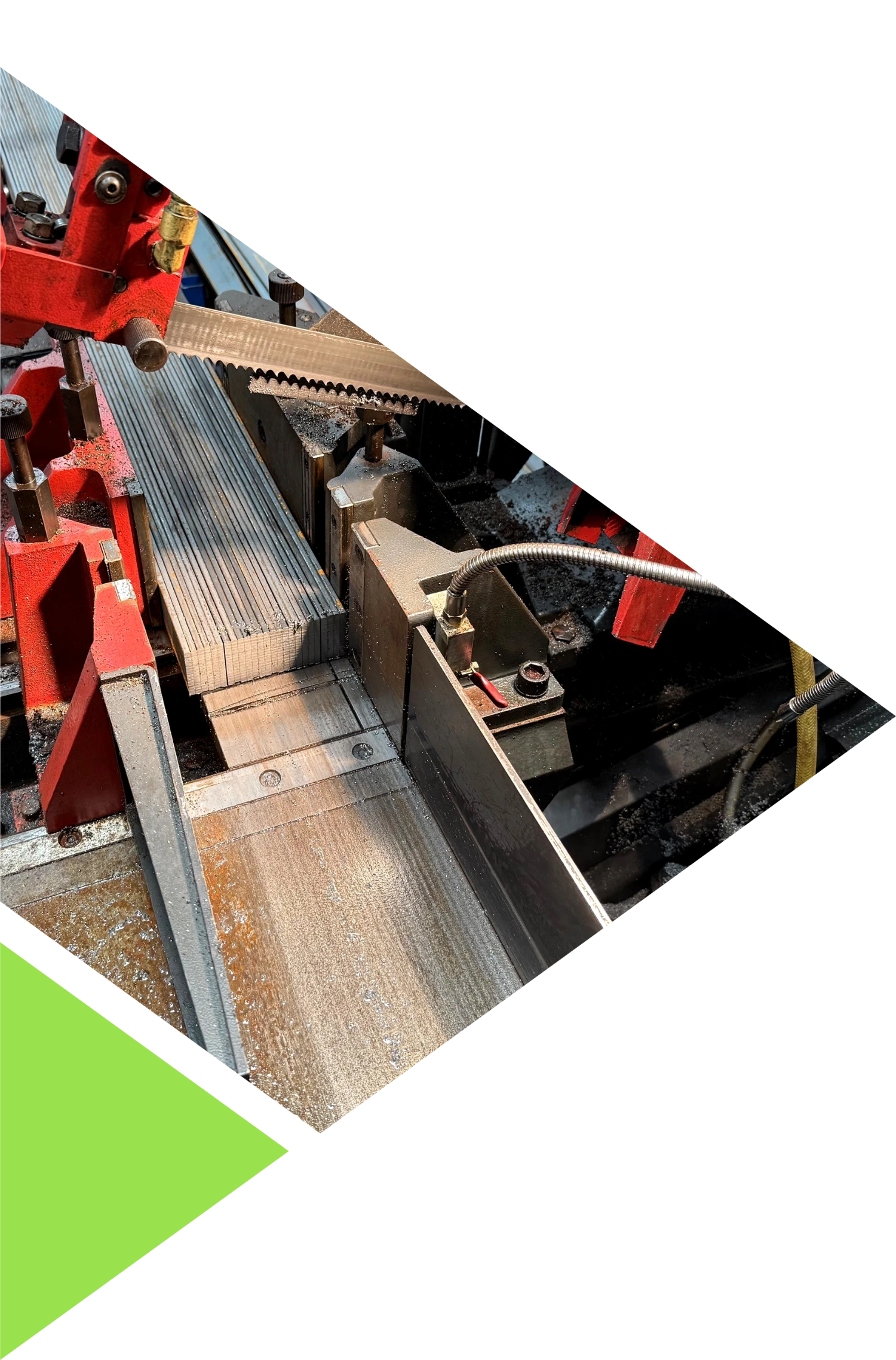 A multi part image with (from top to bottom) a white diagonal line, an image in an angular shape of a metal table saw and a green triangular shape.