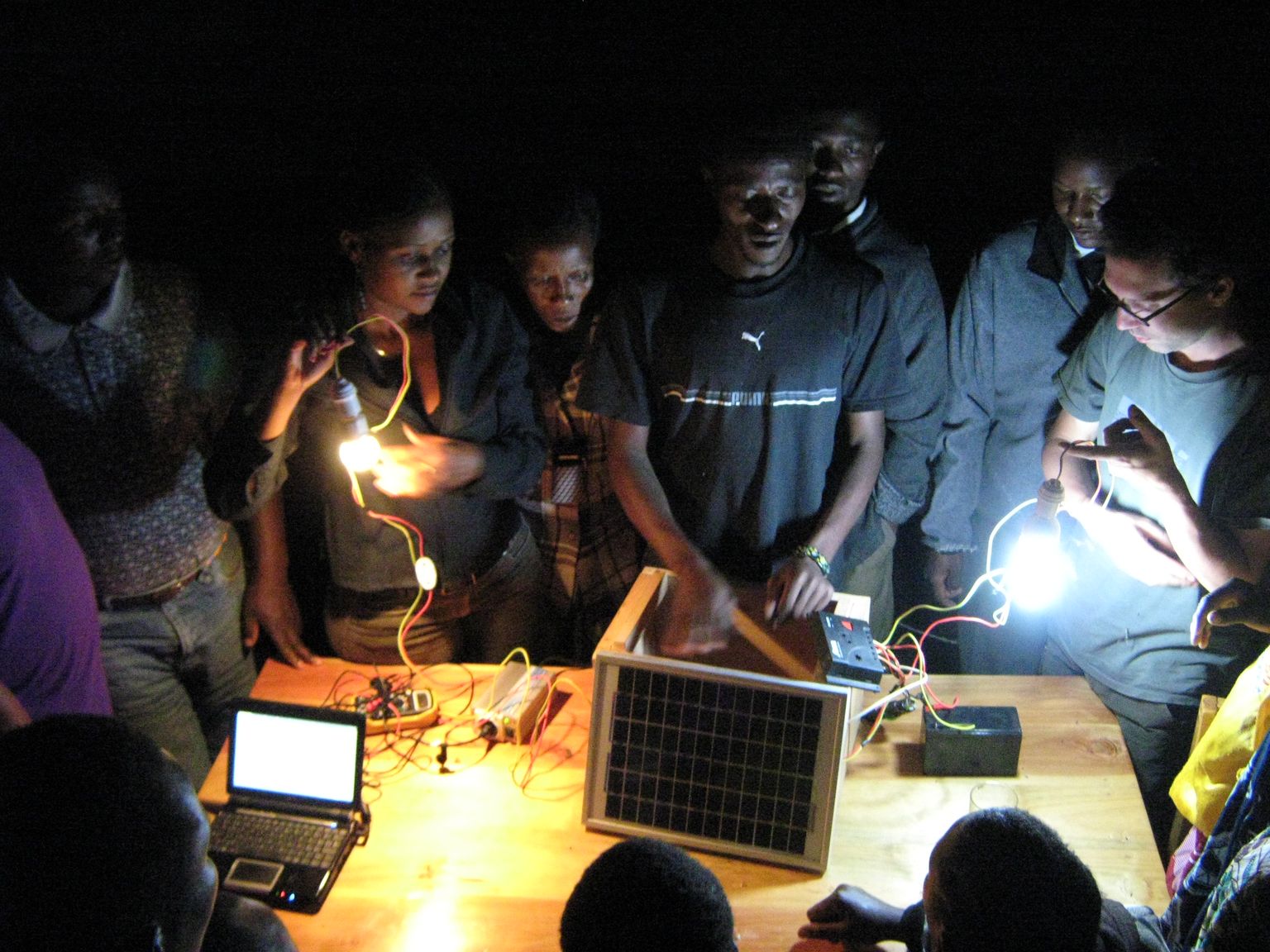 Group of people with bright electricity in a dark room