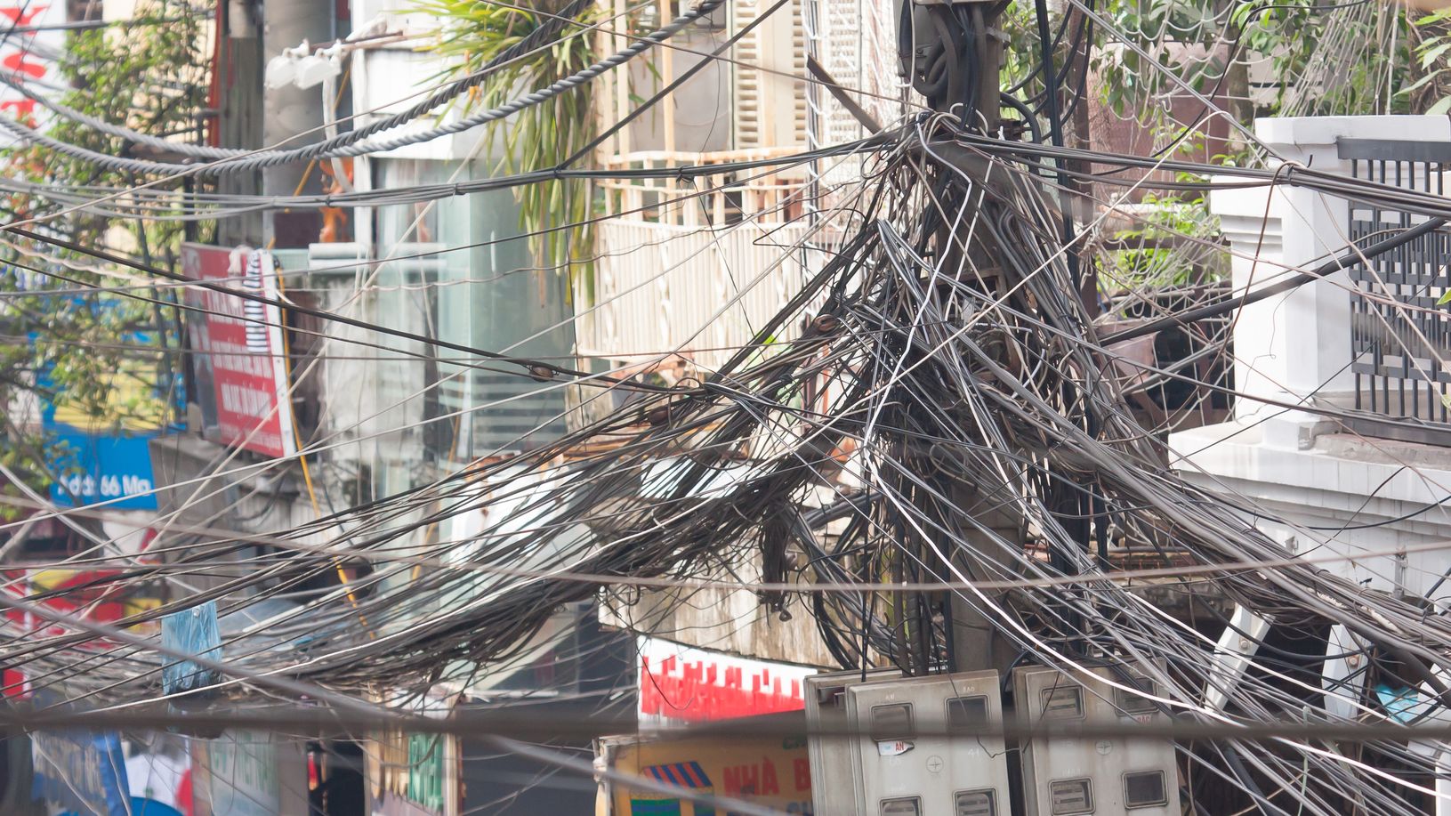 A tangle of power cables and wires in street