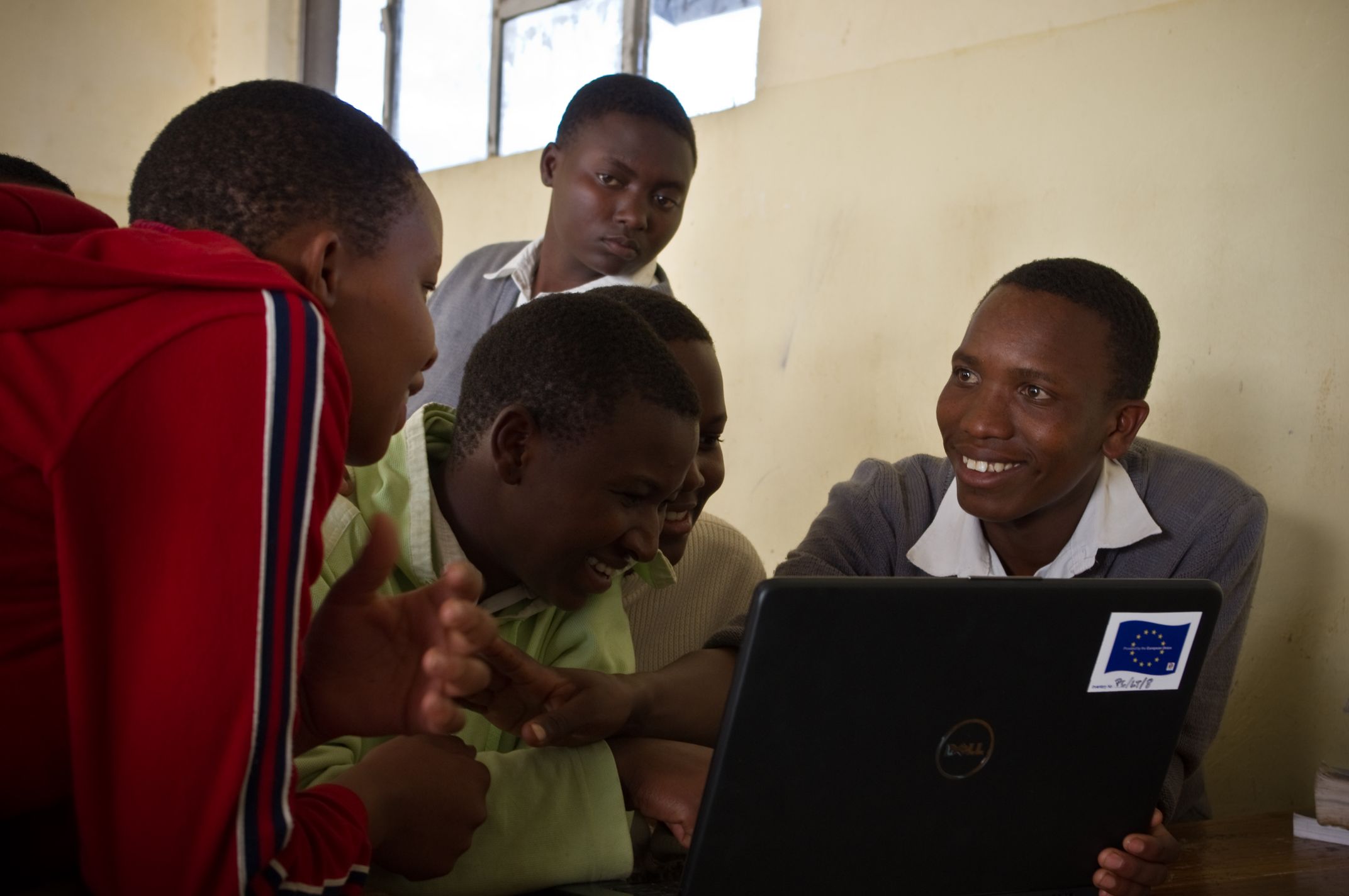 Five young people working in front of a laptop