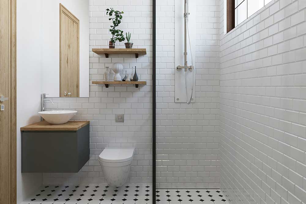 Modern bathroom with white subway tiles, floating sink with wooden countertop, wall-mounted toilet, glass shower partition, and decorative shelves with plants and vases.