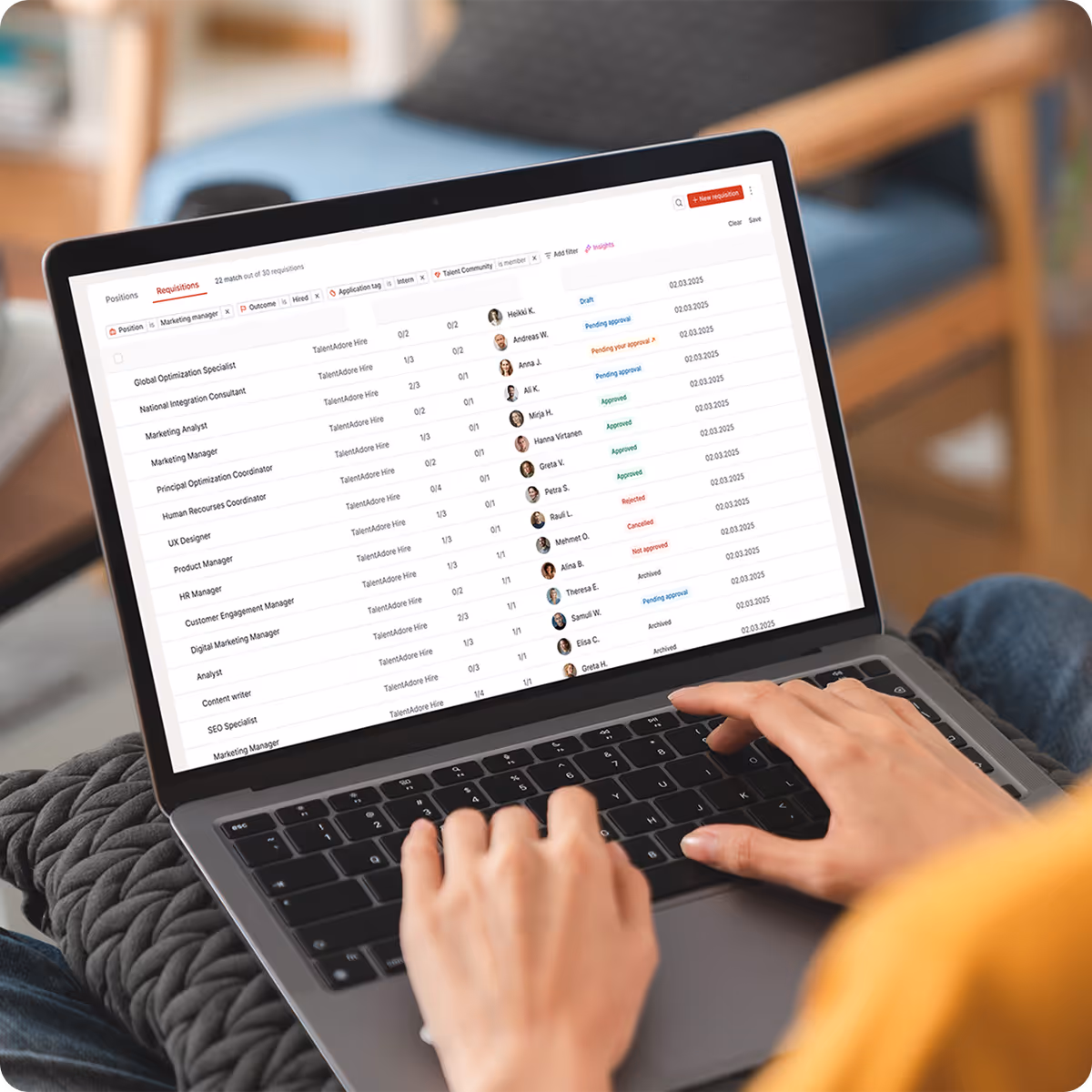 Close-up of a laptop screen showing a recruitment dashboard with job positions, status updates, and applicant details.