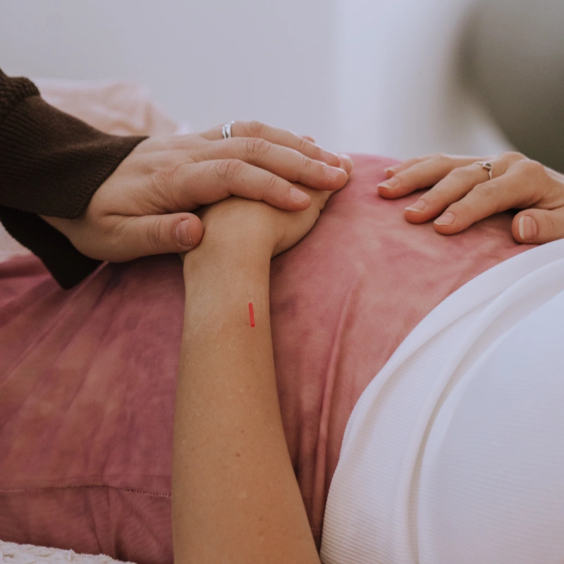 Close-up shot of a pregnant woman having an acuneedling session