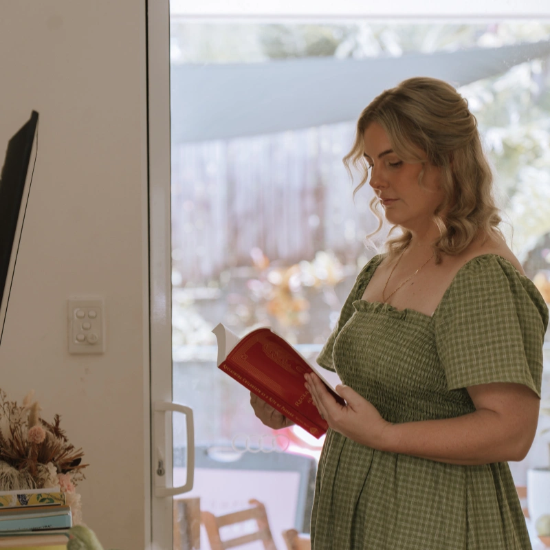 Side view shot of Caitlin reading a book