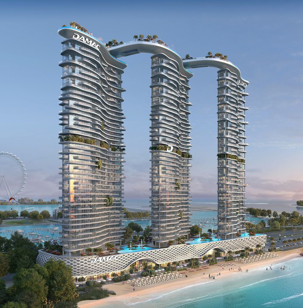 Three modern high-rise towers connected by sky bridges with rooftop greenery, overlooking a beach and marina at sunset.